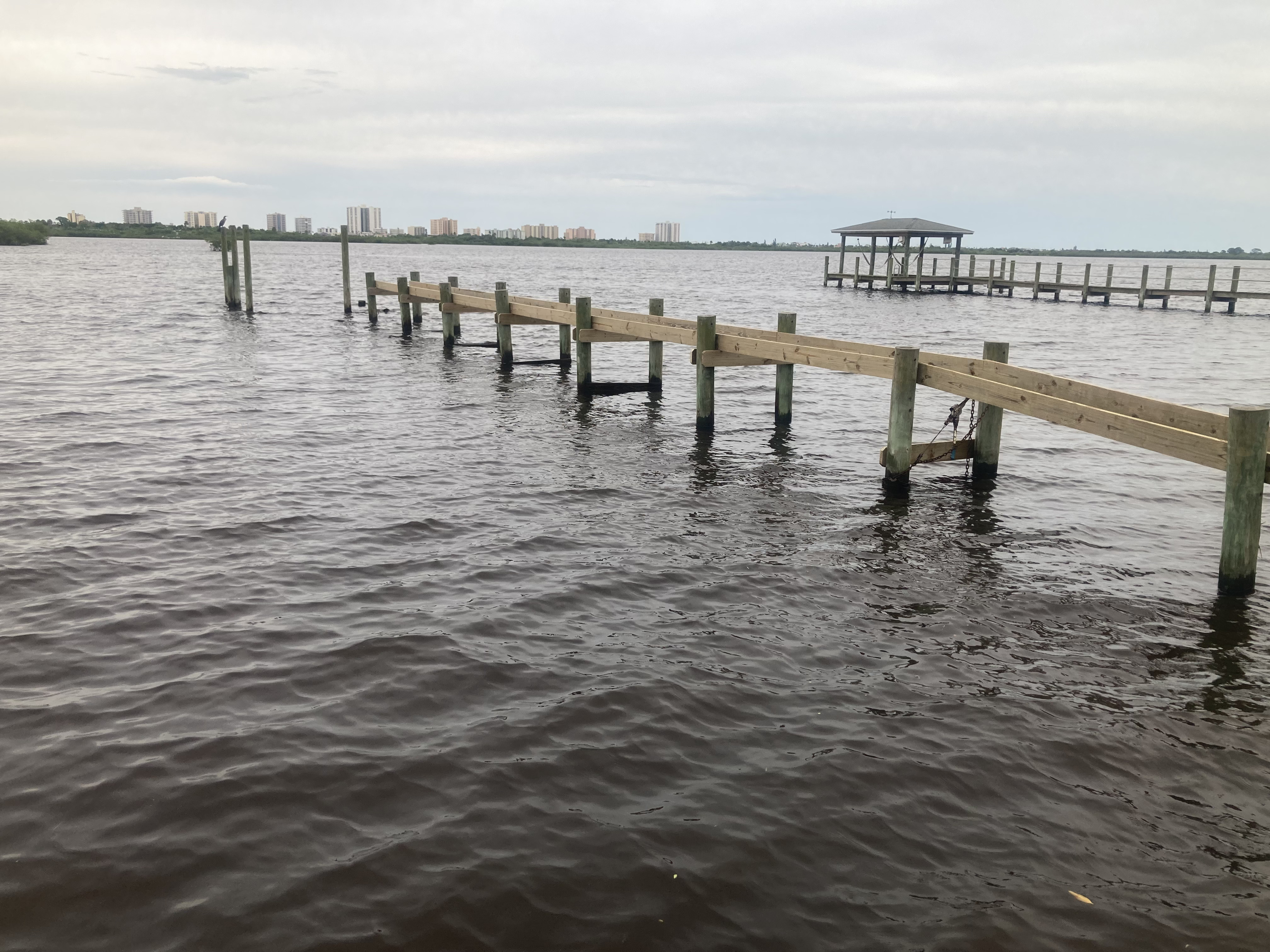 Before: dock pilings and structural framing installed, awaiting decking — mid-construction phase